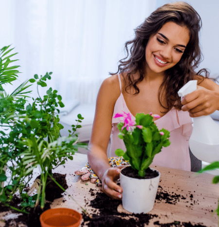 Tip #2: Woman happy watering her plants 